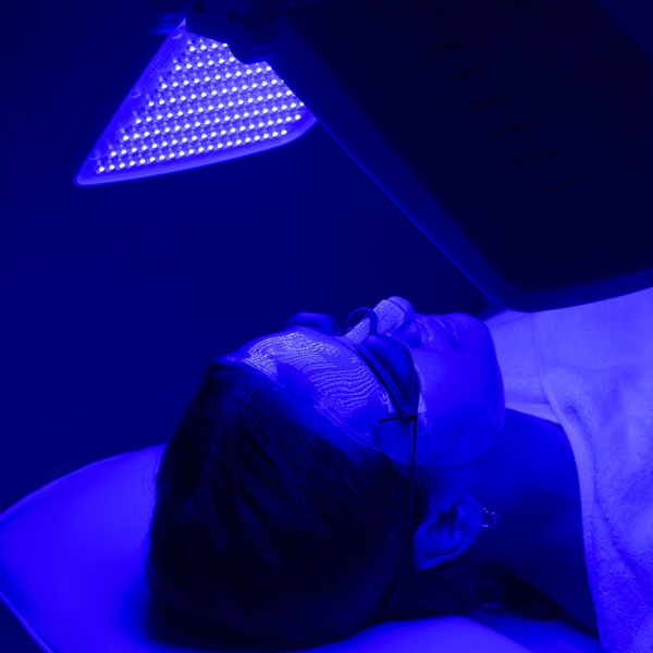 individual under blue light lamp